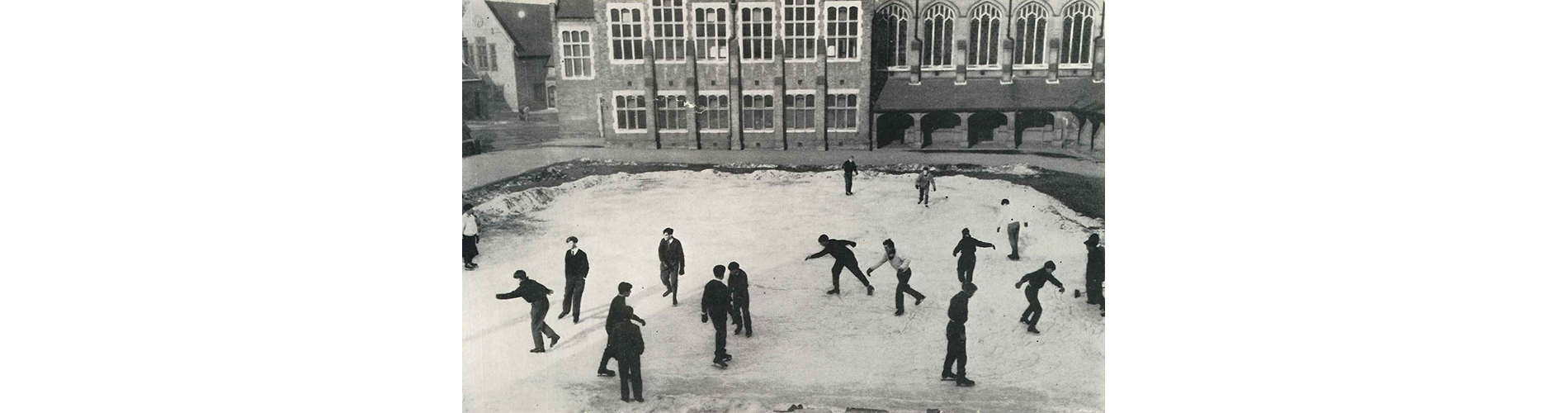 In the winter of 1962/3 outdoor sport for all but the most hardy Long Runners became impossible. Tobogganing, skating on the canal and indoor volleyball took over, until an idea from one of the Housemasters to turn the Grass Quad into a skating rink became a reality.
Mr J C Bevan then took it upon himself, on successive, freezing February nights to resurface the area using water from the swimming pool.